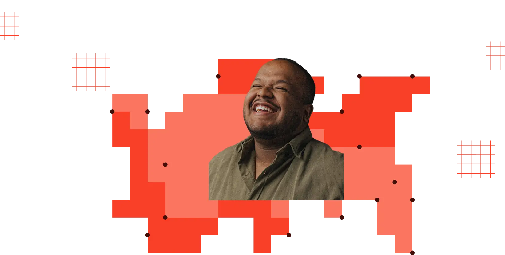 Smiling man with short hair and beard wearing an olive shirt on red geometric background.