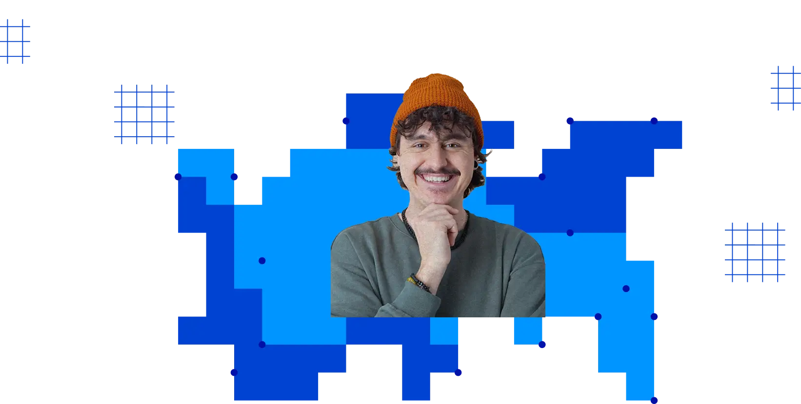 Smiling man with curly hair and mustache wearing an orange beanie and gray sweatshirt on blue background.